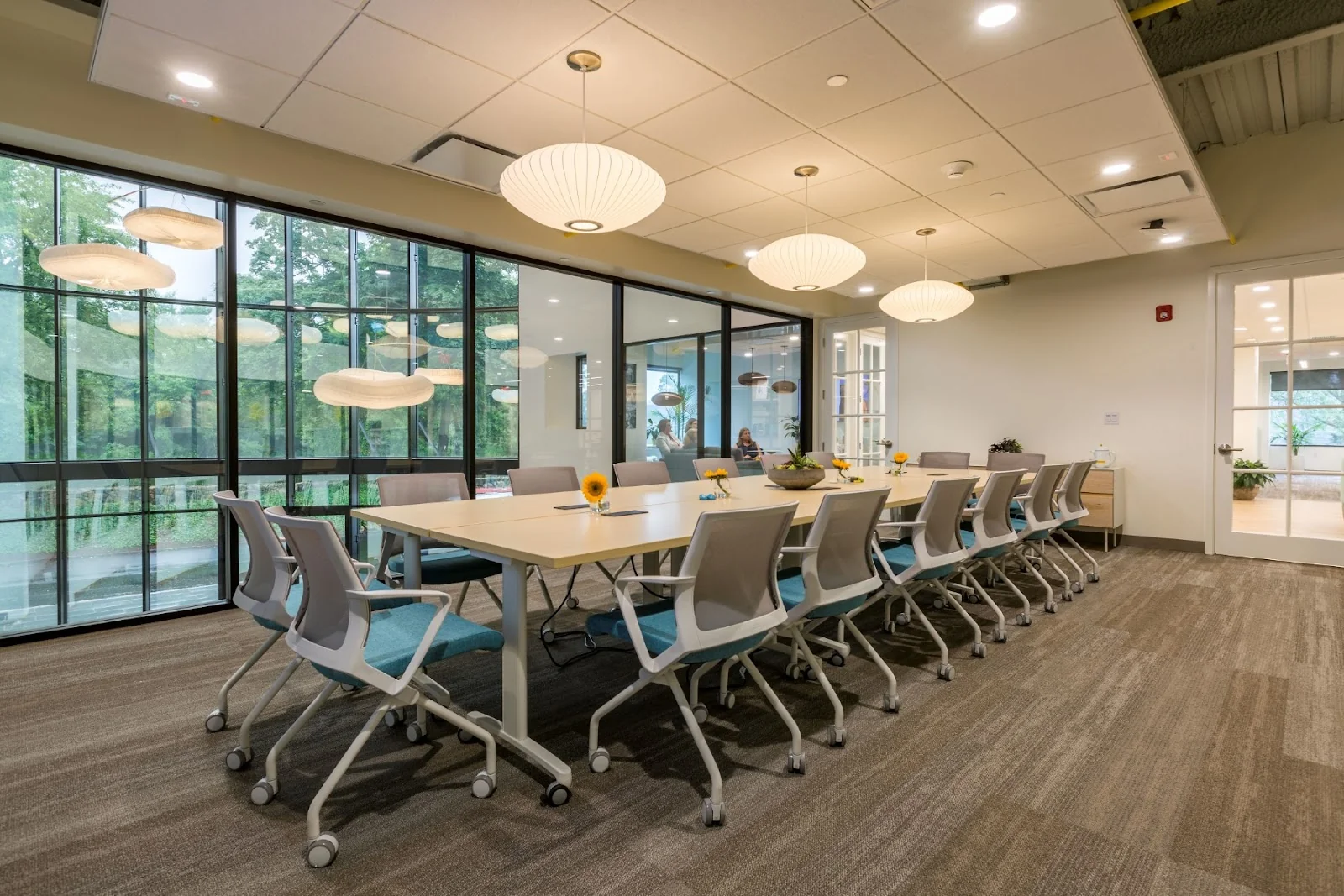 HAYVN Coworking Darien - modern conference room with Nelson Bubble pendants and floor-to-ceiling windows