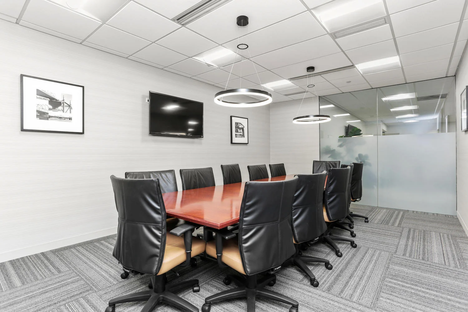 Connecticut Business Centers - executive boardroom with black leather chairs and ring pendant lights
