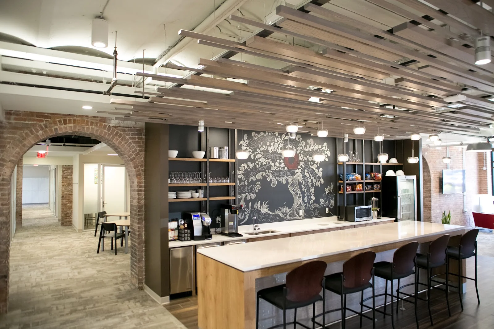 Serendipity Labs Stamford - industrial cafe with exposed brick arches and chalkboard mural