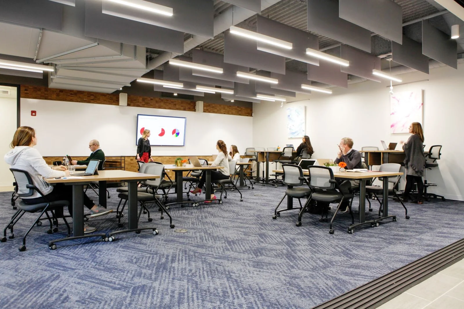 Serendipity Labs Westport - large open coworking floor with people working and acoustic ceiling panels