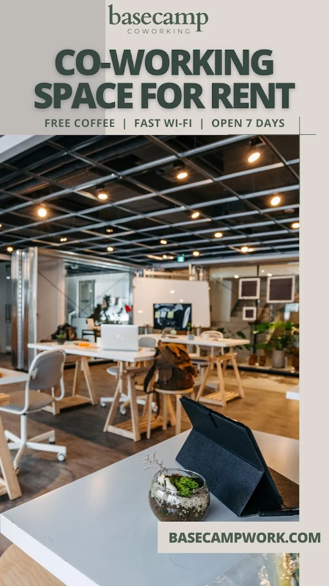 Basecamp Coworking Farmington - industrial coworking space with exposed ceiling and promotional banner