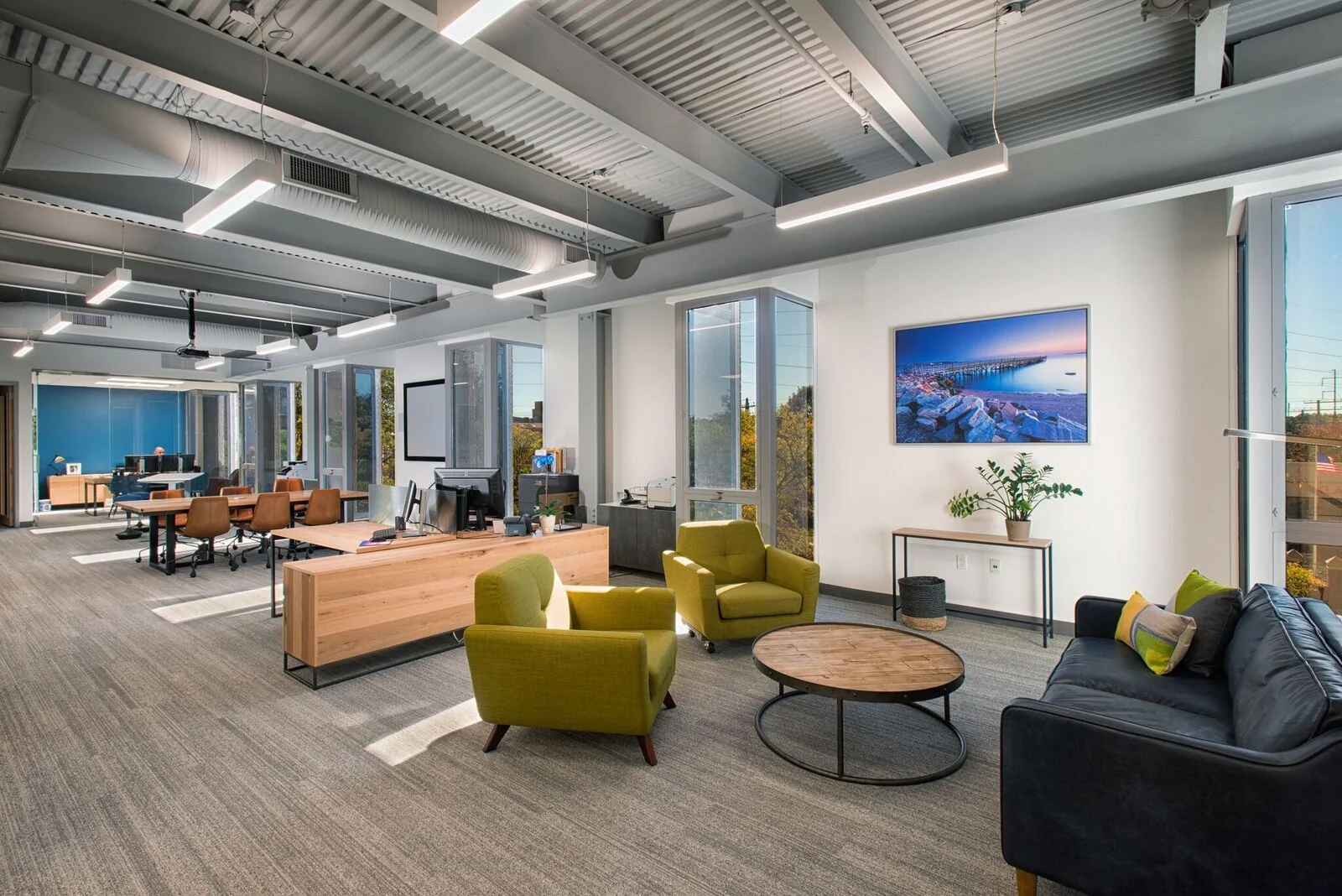 SONO 50 Norwalk - private office with standing desk, blue walls, and Katharine Hepburn artwork