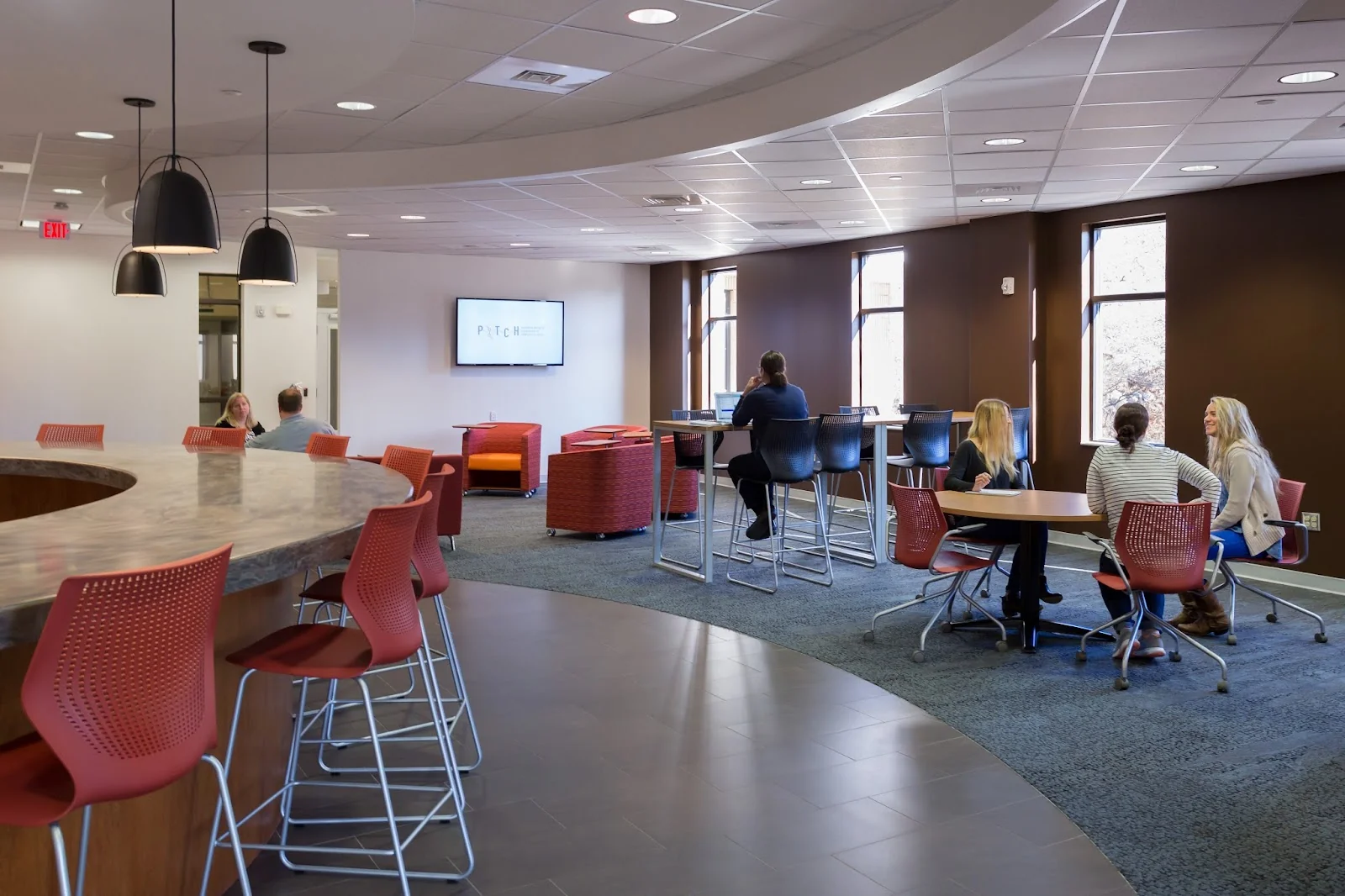 BioCT Innovation Commons Groton - modern collaborative space with PITCH branding and coral seating