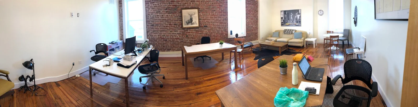 WerkSpace Bridgeport - brick loft coworking with exposed brick, deer artwork, and hardwood floors