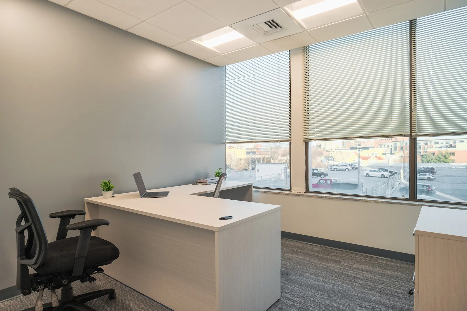 Velocity Flexible Workspace Stamford - modern private office with L-shaped desk and city views