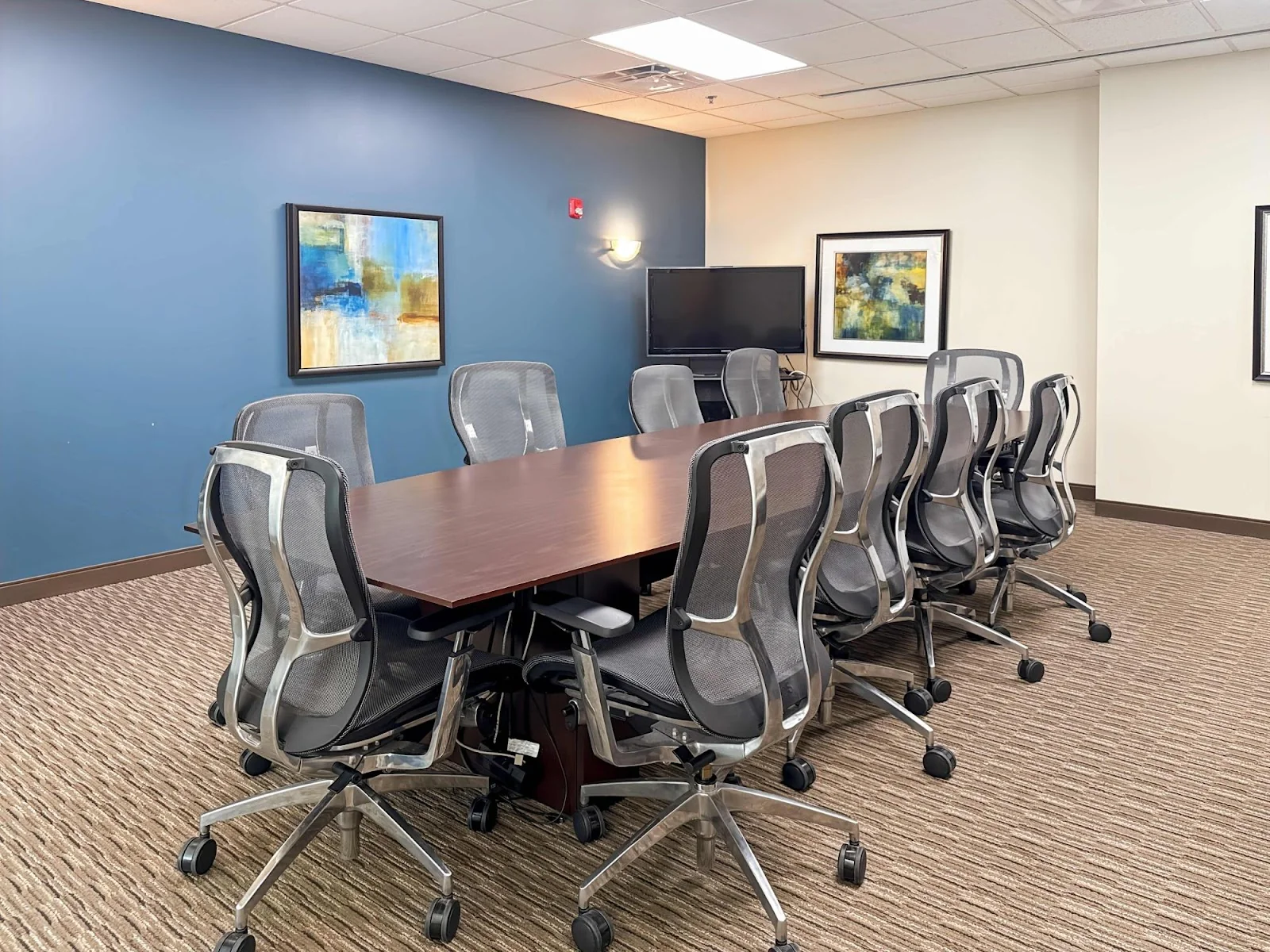Regus Shelton - corporate conference room with blue accent wall and ergonomic mesh chairs