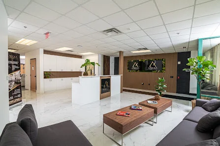 Arixza Corporates upscale marble-floored lobby with white reception desk and wood-paneled accent wall