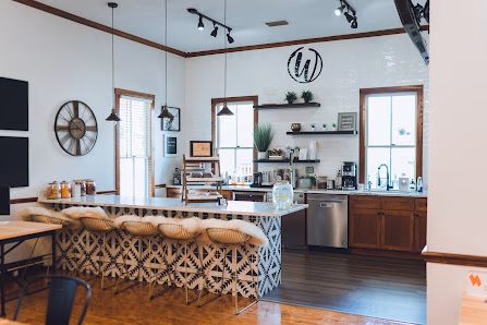 Workspace Collective at Fort King charming kitchen area with patterned tile bar counter, wicker stools, and coffee station