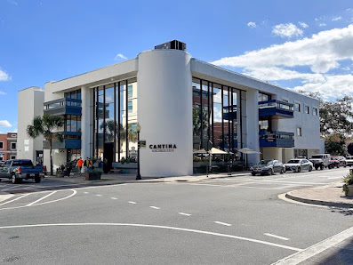 SPACR Ocala white art-deco commercial building on a corner with blue sky