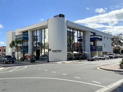 SPACR Ocala white art-deco commercial building on a corner with blue sky