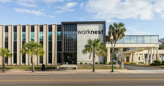 WorkNest Business Center modern mid-century building exterior with large worknest signage and palm trees