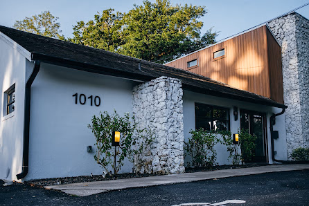 Suite Spaces Orlando charming renovated building at address 1010 with stone pillar entrance and wood-paneled upper facade