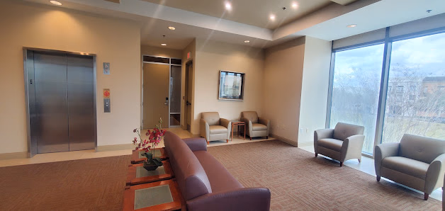 Executive Suites of Baldwin Park corporate elevator lobby with mauve couch, armchairs, and large windows