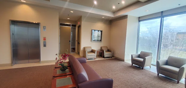 Executive Suites of Baldwin Park corporate elevator lobby with mauve couch, armchairs, and large windows