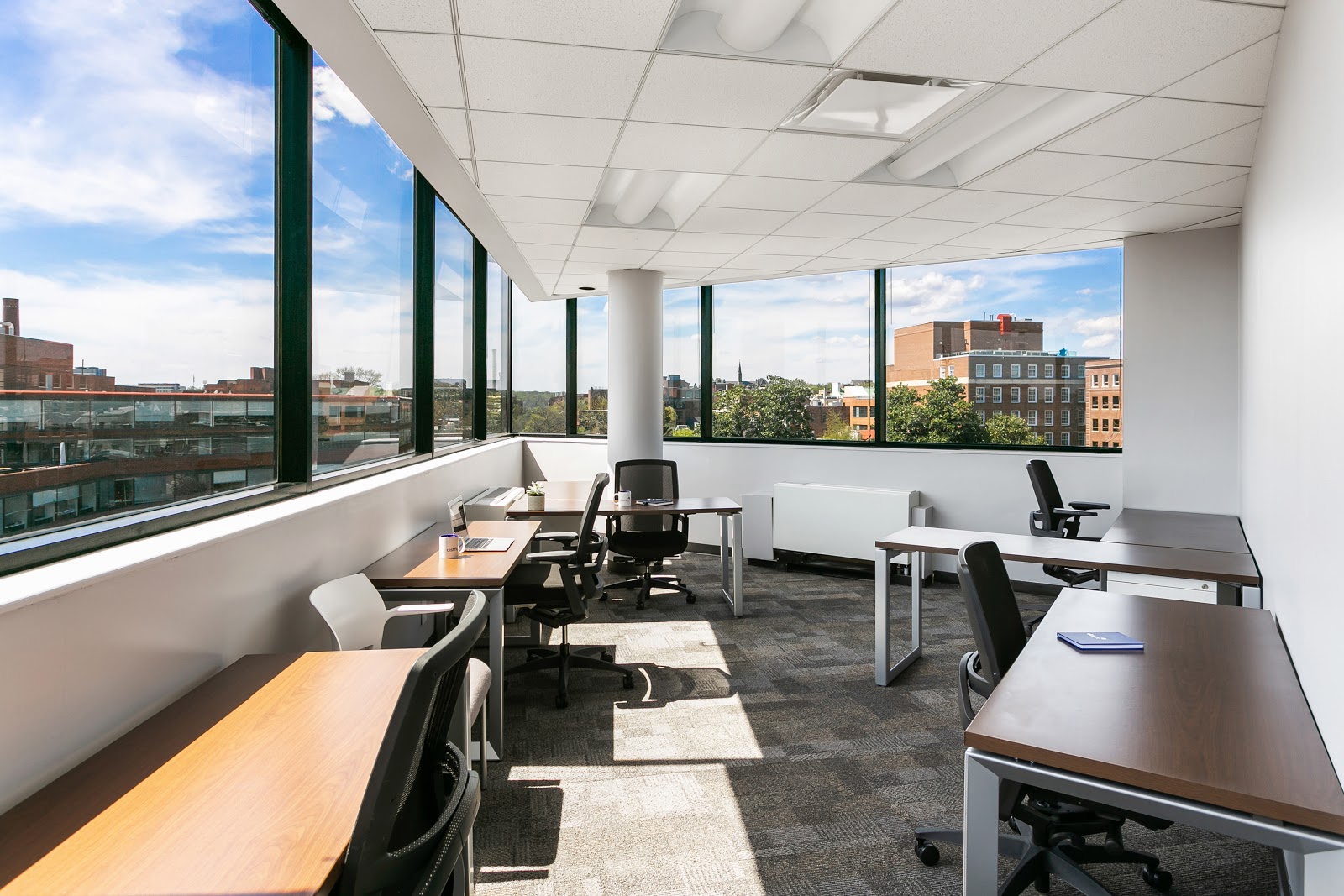 District Offices Georgetown corner office with panoramic windows, city views, and natural light flooding desks