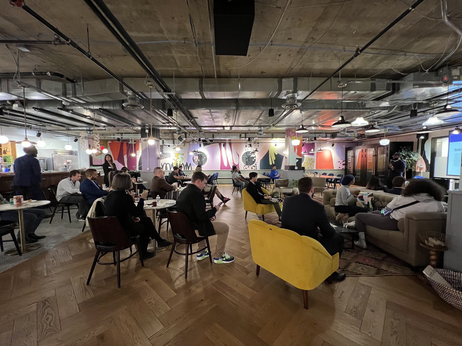 Mindspace Washington coworking event space with colorful murals, herringbone wood floors, and vibrant community seating