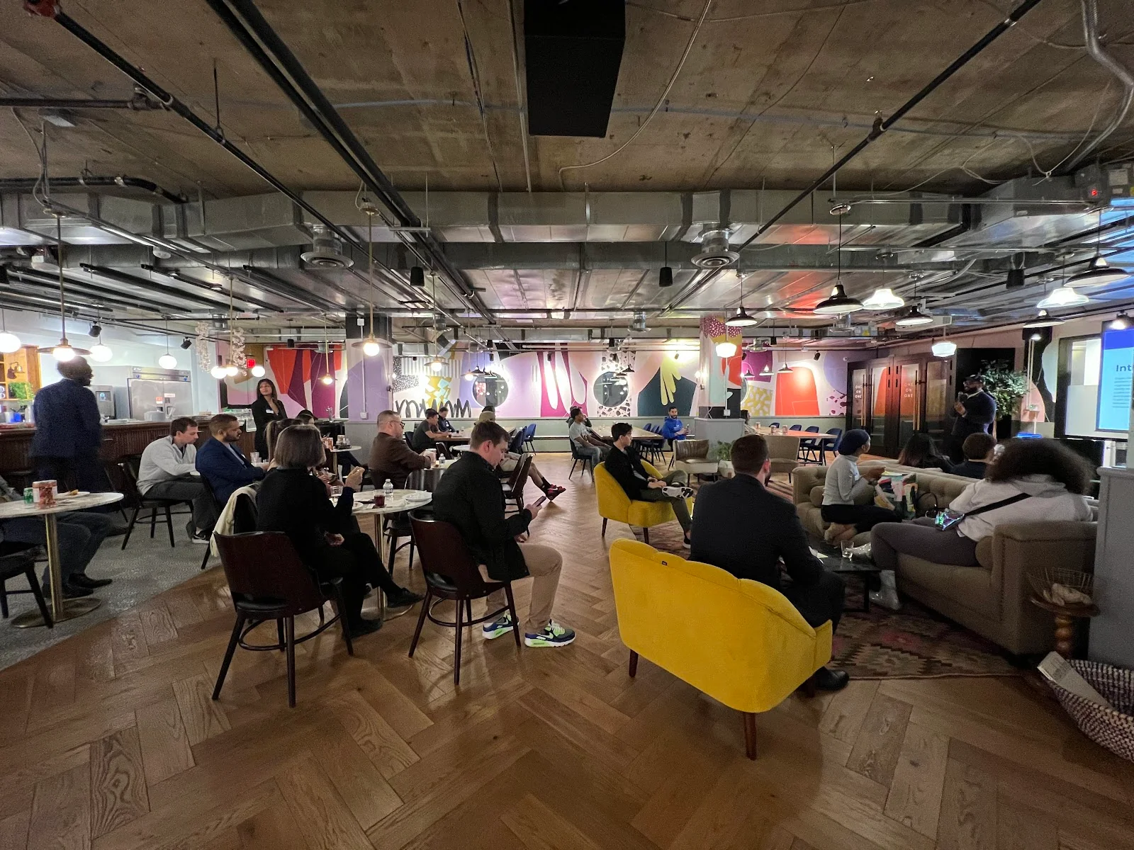 Mindspace Washington coworking event space with colorful murals, herringbone wood floors, and vibrant community seating