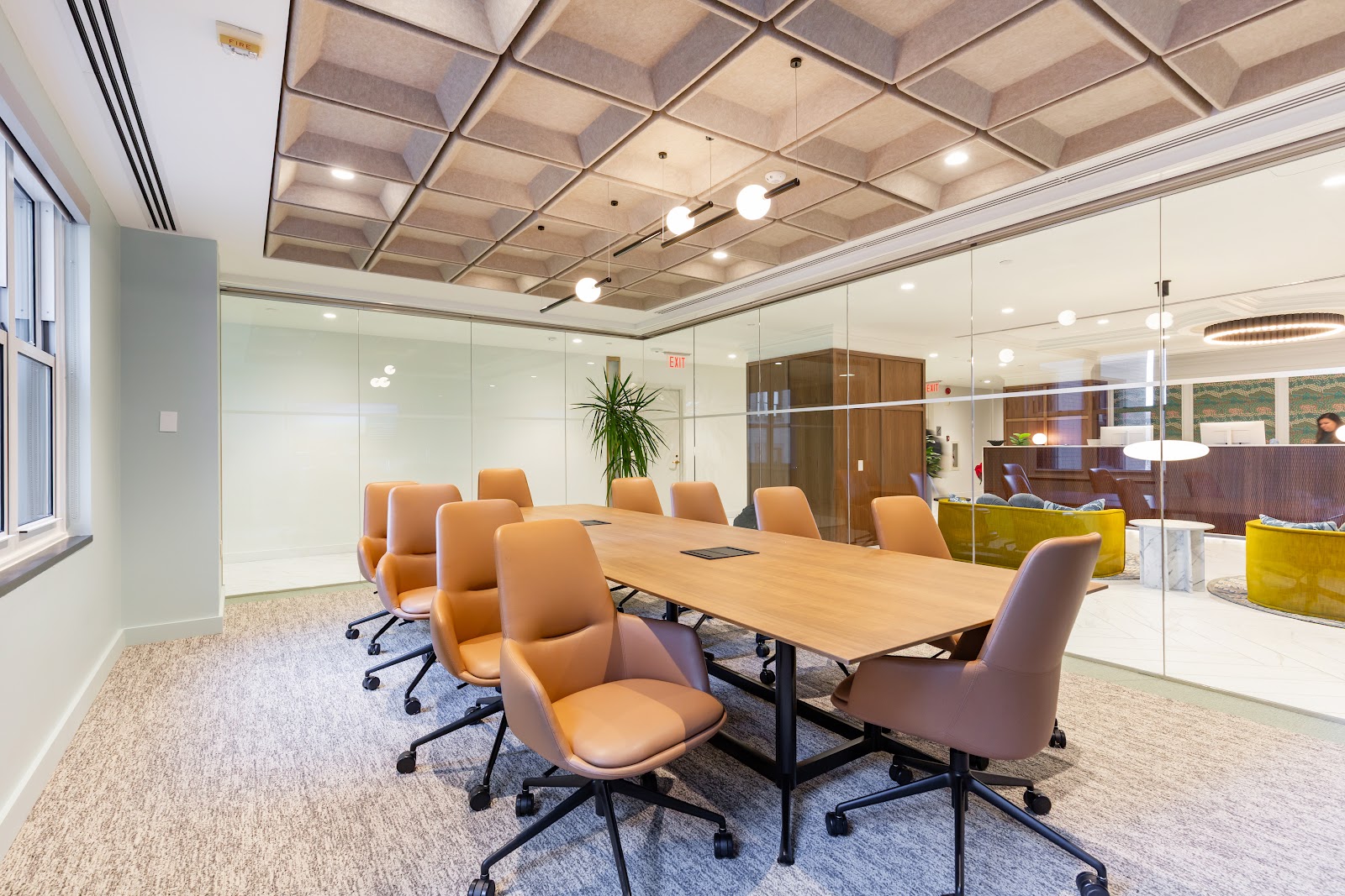 Carr Workplaces The Willard executive boardroom with leather tan chairs, walnut conference table, and geometric acoustic ceiling panels