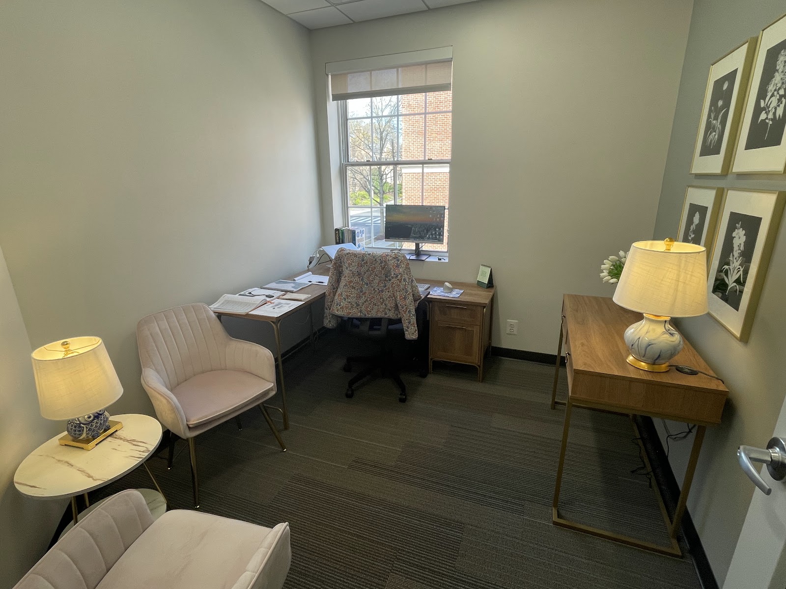 Regus Spring Valley private office with sage green walls, velvet armchair, desk by window, and elegant lamps